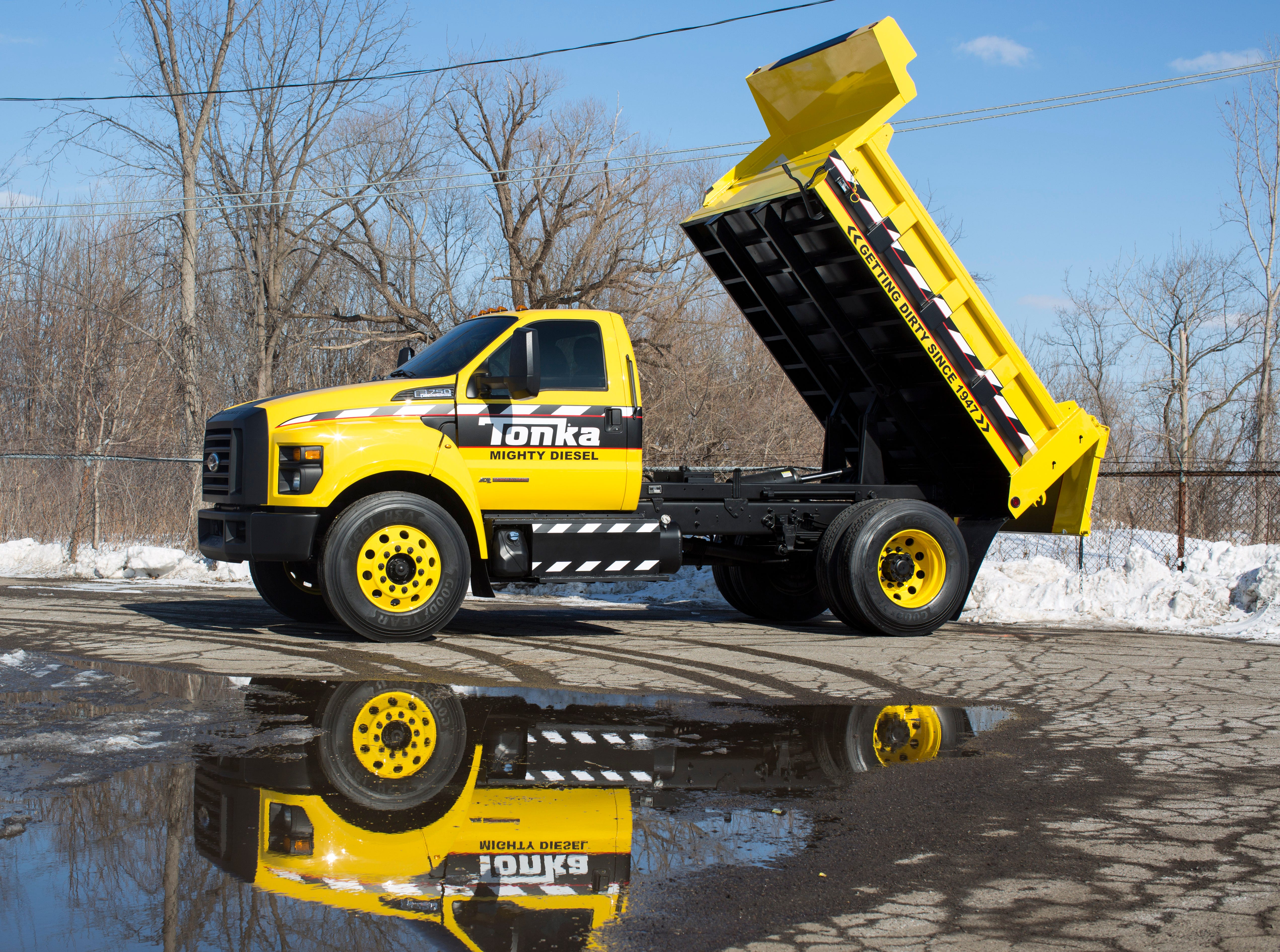semi hauling tonka truck